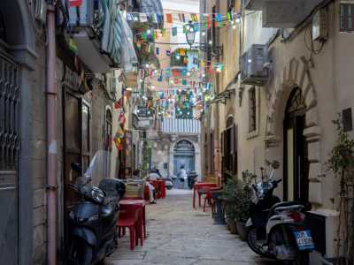 ...con il rombo dei motorini che spesso la percorrono da parte a parte, il profumo di panni stesi e l�eco di saluti in dialetto proveniente dai balconi
